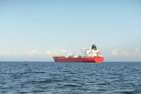 Large red cargo ship (oil chemical tanker, 184 meters length) sailing in the Baltic sea. Freight transportation, logistics, global communications, economy, industry, supply, environmentの写真素材
