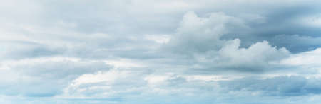 Clear blue sky with glowing clouds after storm at sunset. Soft sunlight. Dramatic cloudscape....