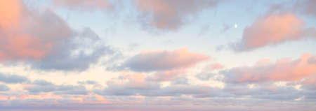 Clear sky, glowing cirrus and cumulus clouds after the storm, soft sunlight. Dramatic sunset cloudscape. Meteorology, weather, climate, heaven, peace. Graphic resources. Picturesque panoramic sceneryの写真素材
