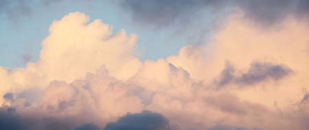 Clear sky, glowing cirrus and cumulus clouds after the storm, soft sunlight. Dramatic sunset...
