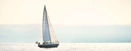 Blue sloop rigged yacht sailing in an open Baltic sea on a clear day, close-up. Riga bay, Latvia....