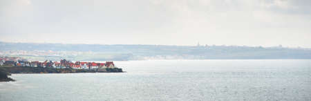 Aerial view of the rocky shore and cliffs of the English Channel. Small village in the background. Cap Gris Nez, Pas-de-Calais, France. Travel destinations, vacations, tourism, national landmarkの写真素材