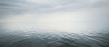 Cloudy blue sky reflecting in the water. Natural mirror. Baltic sea, Ruhnu island, Estonia. Idyllic seascape. Panoramic viewの写真素材