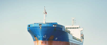 Large blue cargo ship anchored in Strait of Gibraltar. A view from the yacht, close-up. Summer...