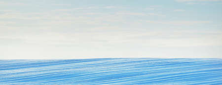 Breathtaking panoramic view of snow-covered field after a blizzard at sunset. Lapland, Finland. Dramatic cloudscape. Winter wonderland. Ice desert. Ecology, weather, climate change, global warmingの写真素材