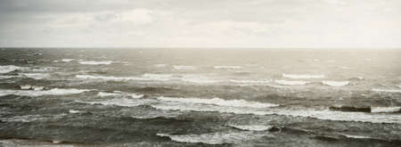 Baltic sea under dramatic sunset clouds after thunderstorm. Waves close-up. Epic seascape. Cyclone,...