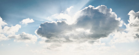 Ornamental clouds. Dramatic sky. Epic storm cloudscape. Soft sunlight. Panoramic image, texture, background, graphic resources, design, copy space. Meteorology, heaven, hope, peace conceptの写真素材