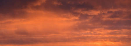Clear sky, glowing cirrus and cumulus clouds after the storm, soft sunlight. Dramatic sunset cloudscape. Meteorology, weather, climate, heaven, peace. Graphic resources. Picturesque panoramic sceneryの写真素材