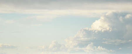 Ornamental clouds. Dramatic sky. Epic storm cloudscape. Soft sunlight. Panoramic image, texture,...