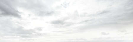 Ornamental clouds. Dramatic sky. Epic storm cloudscape. Soft sunlight. Panoramic image, texture, background, graphic resources, design, copy space. Meteorology, heaven, hope, peace conceptの写真素材