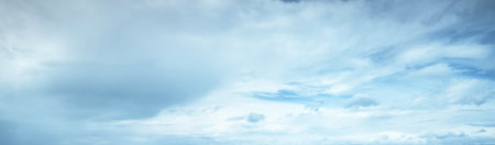 Ornamental clouds. Dramatic sky. Epic storm cloudscape. Soft sunlight. Panoramic image, texture, background, graphic resources, design, copy space. Meteorology, heaven, hope, peace conceptの写真素材
