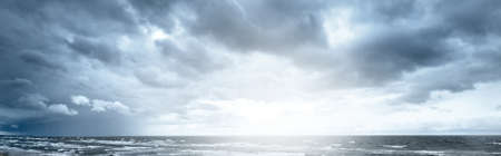 Ornamental clouds. Dramatic sky. Epic storm cloudscape. Soft sunlight. Panoramic image, texture, background, graphic resources, design, copy space. Meteorology, heaven, hope, peace conceptの写真素材