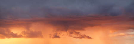 Clear sky, glowing cirrus and cumulus clouds after the storm, soft sunlight. Dramatic sunset cloudscape. Meteorology, weather, climate, heaven, peace. Graphic resources. Picturesque panoramic sceneryの写真素材