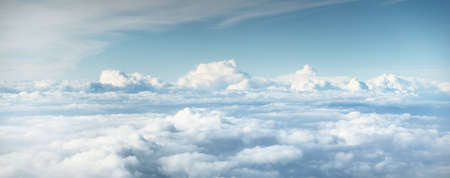 Epic cloudscape. White ornamental cumulus clouds, view from an airplane. Fickle weather, storm, cyclone. Abstract natural pattern, texture, background, wallpaper, 3D, graphic resources, designの写真素材