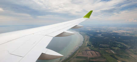 Rivers. lakes, valleys, fields from above. Panoramic view from an airplane window. Cloudy blue sky. Landscape, cloudscape. Transportation, passengers, tourism, travel destinations, wanderlustの写真素材