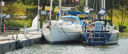 Classic and modern sailboats moored to a pier in a yacht marina. Stockholm sail club, MÃ¤laren...