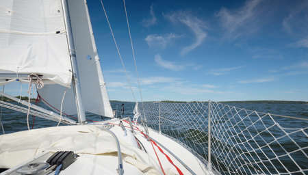 White yacht sailing on a clear day. View of the deck, mast, bow. 32 feet swedish built cruising...