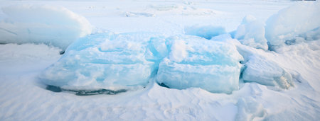 Fresh snow texture. Panoramic view of snow-covered field after a blizzard at sunset. Winter...