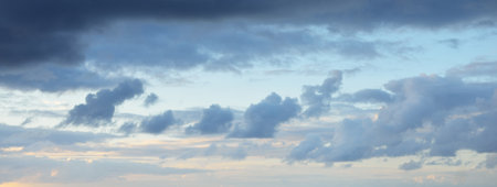 Ornamental clouds. Dramatic sky. Epic storm cloudscape. Soft sunlight. Panoramic image, texture,...