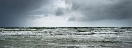 Baltic sea under the dark dramatic clouds after thunderstorm. Ventspils, Latvia. Epic seascape....