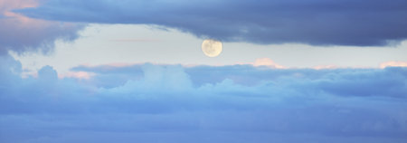 Clear sky, glowing cirrus and cumulus clouds after the storm, soft sunlight. Dramatic sunset cloudscape. Meteorology, weather, climate, heaven, peace. Graphic resources. Picturesque panoramic sceneryの写真素材