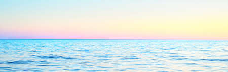 Golden sunset sky reflecting in the water, panoramic view from the sailing boat. Setting sun. Waves...