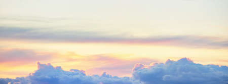Clear blue sky. glowing pink and golden cirrus and cumulus clouds after storm, soft sunlight....
