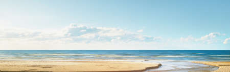 Clear blue sky above the sandy Baltic sea shore after a thunderstorm. Dry river, sand texture close-up. Latvia. Dramatic sky. Ecology, environmental conservation, fickle weather, climate changeの写真素材