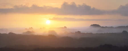 Picturesque scenery of the valleys near Pointe de Pen Hir, Brittany, France. Panoramic aerial view. Fog. haze, pure morning sunlight. Colorful cloudscape. Travel destinations, national landmarksの写真素材