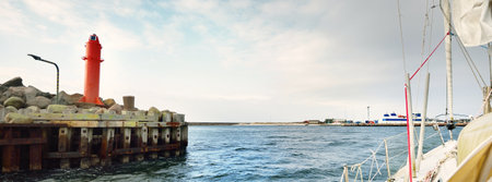 Port entrance mole close-up. A view from the sailing boat. Waves and water splashes. Kattegat, Anholt island, Denmark. Travel destinations, navigation, transportation themeの写真素材