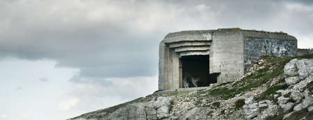 One of the fortifications of the Atlantic Wall in Brittany, France. Dramatic cloudscape. Travel...