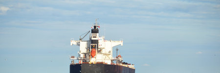 Large bulk carrier (ship) sailing in the Baltic sea to Riga port, Latvia. A view from the yacht....