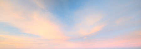Clear blue sky with glowing pink and golden clouds after the storm. Dramatic sunset cloudscape. Concept art, meteorology, heaven, hope, peace. Graphic resources, picturesque panoramic sceneryの写真素材