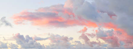 Clear blue sky, red, pink, golden cirrus and cumulus clouds after storm. Dramatic sunset cloudscape....