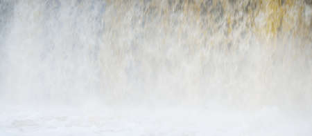 Frozen Keila waterfall, icicles and water splashes close-up. Winter in Estonia. Abstract natural...