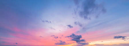 Clear blue sky with glowing pink and golden clouds after the storm. Dramatic sunset cloudscape. Concept art, meteorology, heaven, hope, peace. Graphic resources, picturesque panoramic sceneryの写真素材