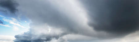 Ornamental clouds. Dramatic sky. Epic storm cloudscape. Soft sunlight. Panoramic image, texture, background, graphic resources, design, copy space. Meteorology, heaven, hope, peace conceptの写真素材