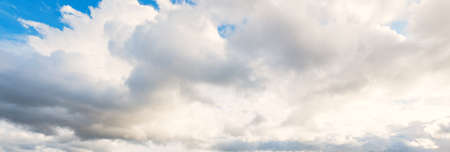 Ornamental clouds. Dramatic sky. Epic storm cloudscape. Soft sunlight. Panoramic image, texture, background, graphic resources, design, copy space. Meteorology, heaven, hope, peace conceptの写真素材