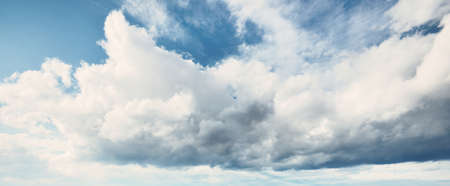 Ornamental clouds. Dramatic sky. Epic storm cloudscape. Soft sunlight. Panoramic image, texture, background, graphic resources, design, copy space. Meteorology, heaven, hope, peace conceptの写真素材