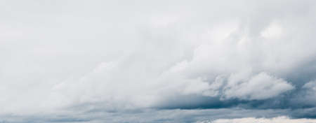Ornamental clouds. Dramatic sky. Epic storm cloudscape. Soft sunlight. Panoramic image, texture, background, graphic resources, design, copy space. Meteorology, heaven, hope, peace conceptの写真素材