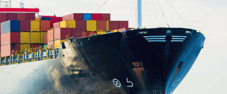 Large cargo container ship sailing in an open sea. USA. Panoramic view from the sailing boat....