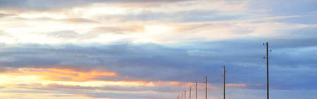 Clear blue sky with glowing pink and golden clouds after the storm. Dramatic sunset cloudscape....