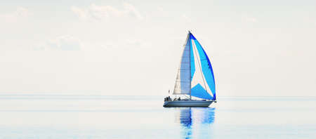 Sailing yacht regatta. Modern sailboat racing with blue spinnaker sails. Clear summer day. Kiel,...