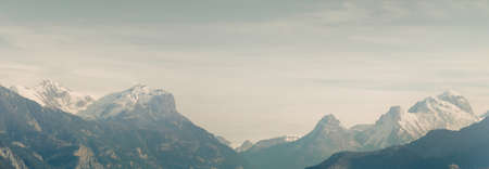 Mountain peaks on a sunny winter day. Clear sky, soft sunlight. French Alps, Ecrins massif, France. Panoramic landscape. Nature, seasons, ski, vacations, wanderlust conceptsの写真素材