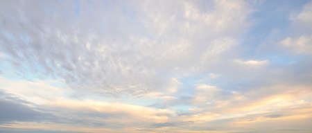 Ornamental clouds. Dramatic sky. Storm cloudscape. Soft sunlight. Panoramic image, texture,...