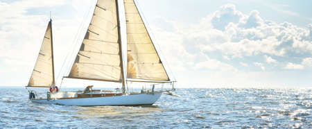 Old expensive vintage two-masted sailboat (yawl) close-up, sailing in an open sea. Coast of Maine,...