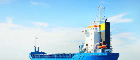 Large cargo ship sailing in the Baltic sea. Concept seascape. Panoramic view from the sailing boat....