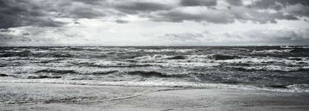 Baltic sea under the dark dramatic clouds after thunderstorm. Latvia. Epic seascape. Cyclone, gale, storm, rough weather, meteorology, ecology, climate change, natural phenomenonの写真素材