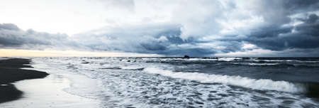 Storm clouds above the Baltic sea in winter, long exposure. Dramatic sunset sky, waves and water...