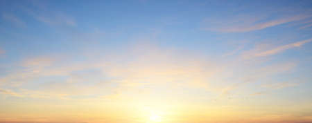 Clear blue sky. glowing pink and golden cirrus and cumulus clouds after storm, soft sunlight. Dramatic sunset cloudscape. Meteorology, heaven, peace, graphic resources, picturesque panoramic sceneryの写真素材